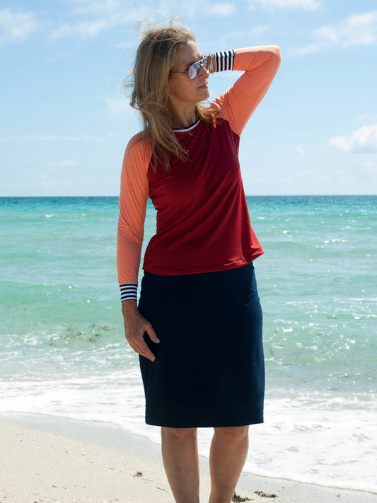 Women's active knew length skirt with built in shorts. Color navy blue.