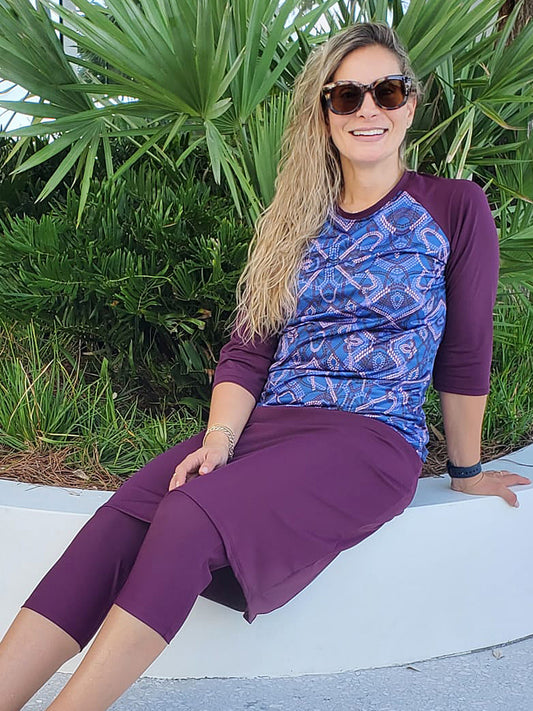 Women's long sleeve swim top in purple haze pattern with purple sleeves.