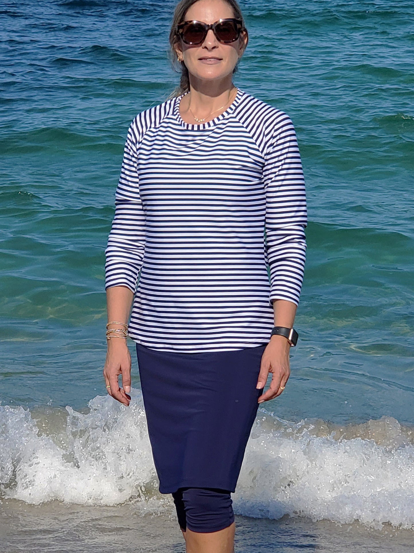 Women's modest long sleeve swim top in navy blue striped pattern.