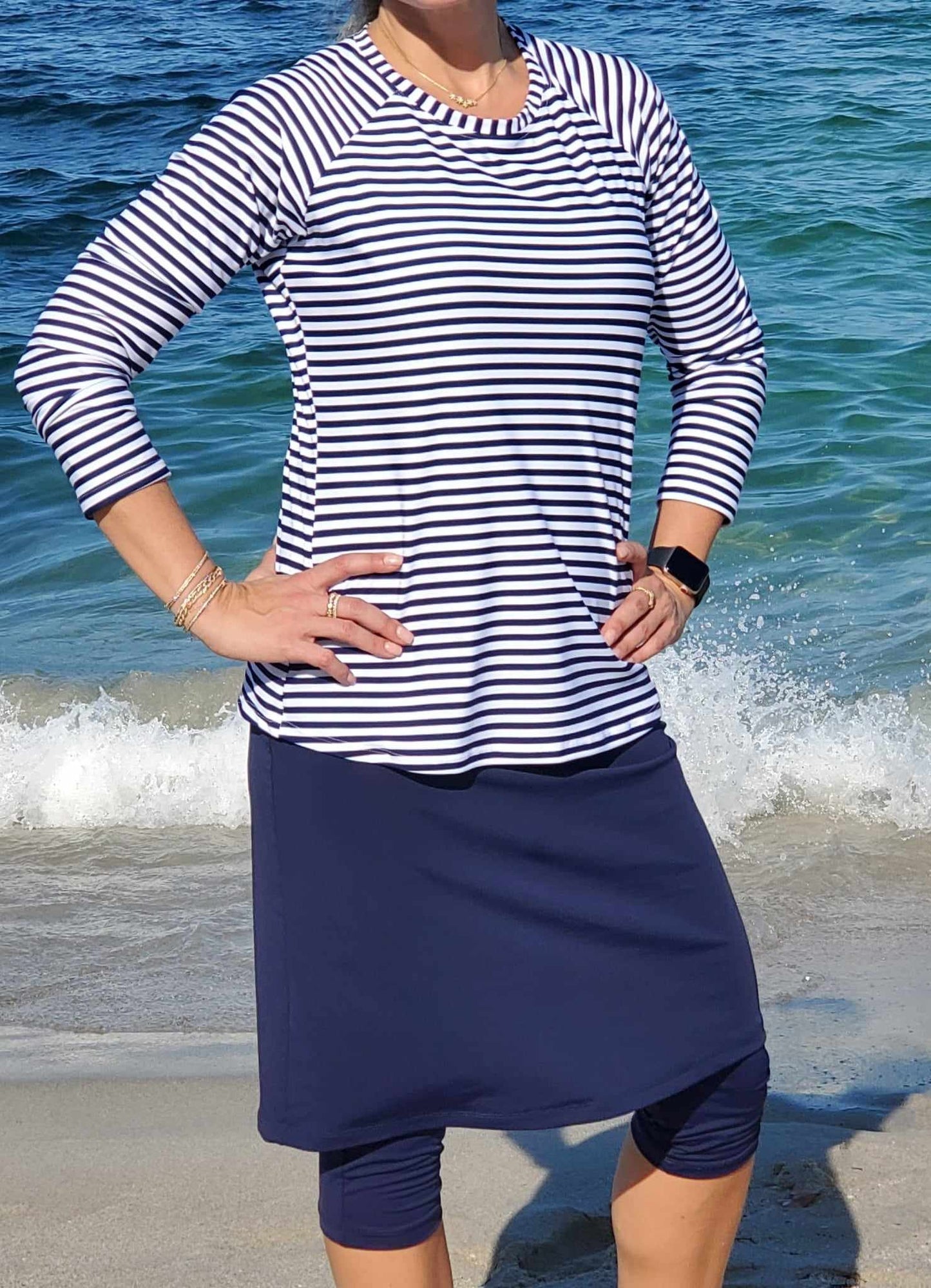 Women's modest long sleeve swim top in navy blue striped pattern.