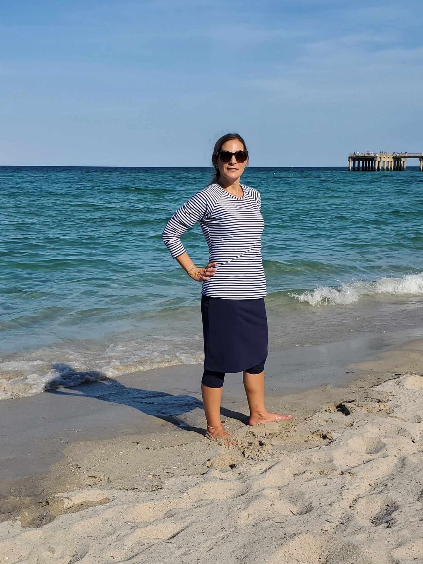 Women's modest long sleeve swim top in navy blue striped pattern.